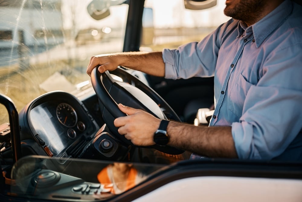 close-truck-driver-driving-transport-vehicle