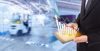 Business hand holding growth chart of transport business on tablet with warehouse