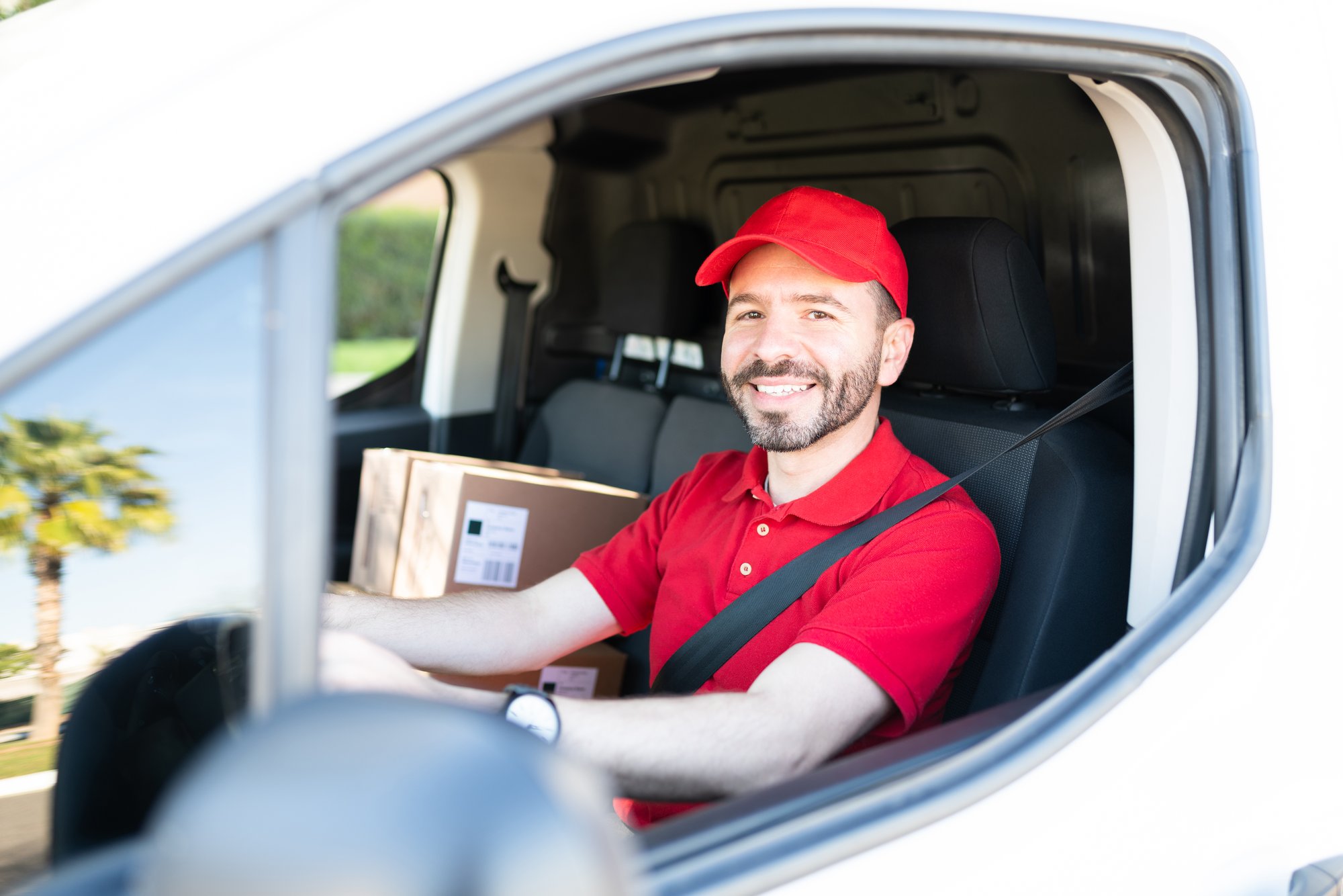 man smiling and driving cargo van man smiling and driving cargo van